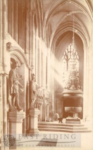 Beverley Minster interior, nave south aisle west end, with 18th century statues and font, Beverley c.1900s