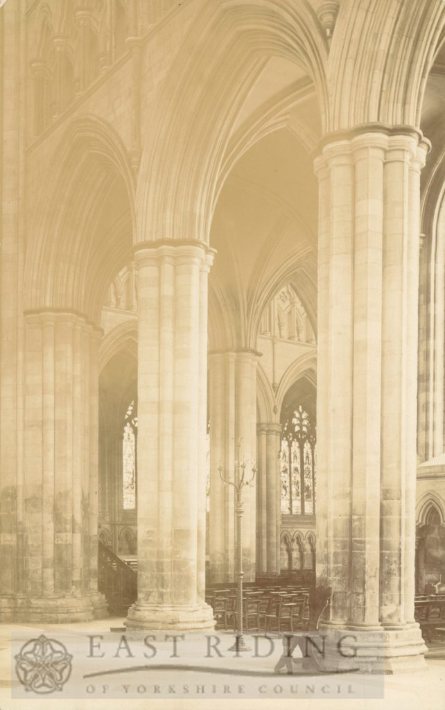 Beverley Minster interior, north transept west aisle piers, with east end of nave in background, Beverley 1900s