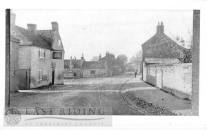 Village street from north with Black Swan and cross, Brandesburton 1900s